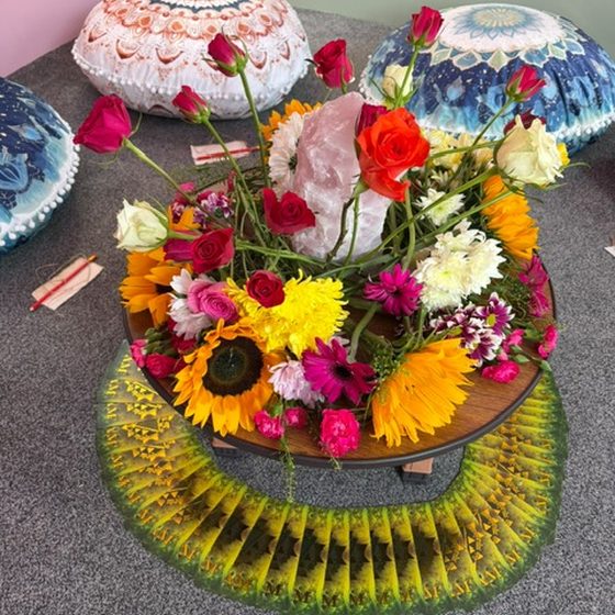 Fresh flower centrepiece on the low table at a group evening